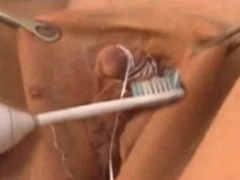 Perv dude cleans big swollen clit with tooth brush