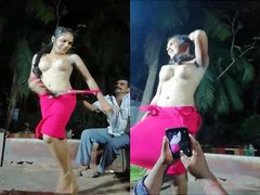Naked Desi woman is dancing for the crowd and everyone is watching the XX