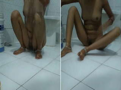 Hot Indian baby with ankle bracelets sits on the floor and has fun while bathing