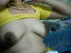 Desi woman with incredible boobs and round areolas wearing a yellow XXX saree